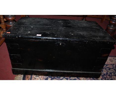 A Victorian black painted pine hinge-top tool chest with iron end carry handles