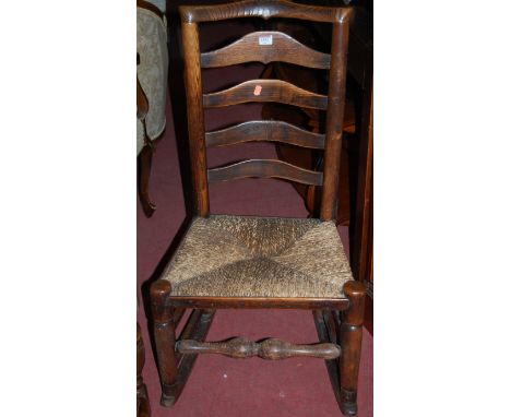 A circa 1900 elm and oak rush seat ladder back rocking chair