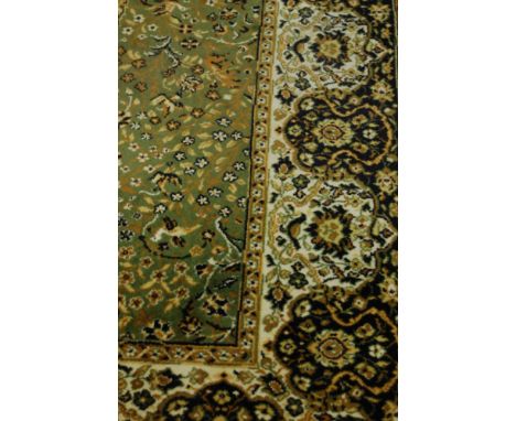 A Persian style machine woven green ground woollen carpet, 315x273cm