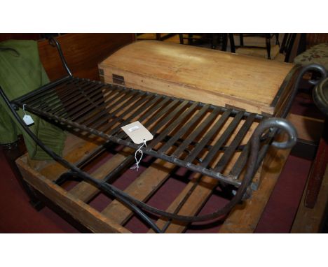A contemporary wrought iron two seater folding bench of X-frame form, width 120cm