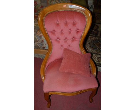 A pair of contemporary beech and pink button back upholstered nursing chairs