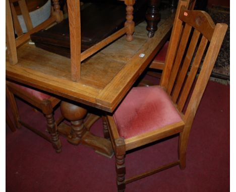 A 1930s light oak drawleaf dining table; together with a set of six 1930s light oak splatback dining chairs, each having pink