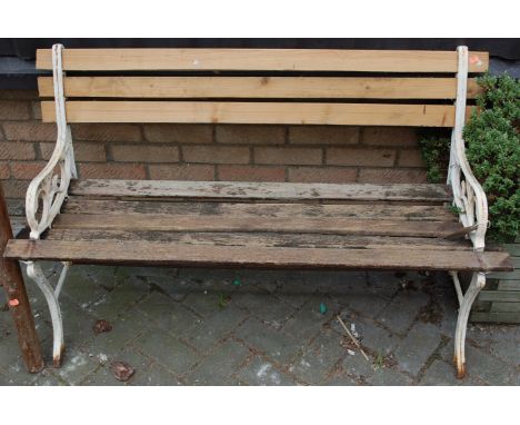 A white painted cast metal and slatted two seater garden bench