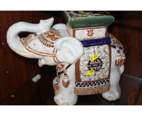 A CERAMIC STAND IN THE FORM OF AN ELEPHANT 