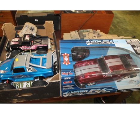 A BOXED MAISTO REMOTE CONTROL 1:12 SCALE 1967 FORD MUSTANG GT, together with two remote control monster trucks, a hobby engin