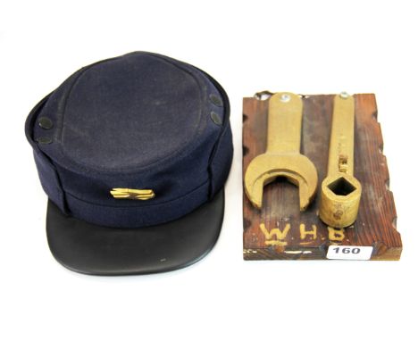 Two vintage railway line working tools together with a guards cap.