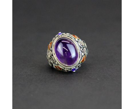 A Chinese silver and enamelled filigree ring set with cabochon amethyst, top W. 2.3cm.