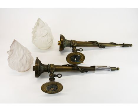 A pair of ornate brass lantern torch wall light brackets with frosted glass flame shades, H. with flame 60cm.