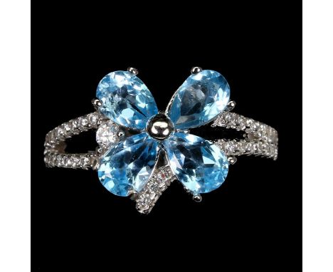 A matching 925 silver flower shaped ring set with oval cut blue topaz, (O).