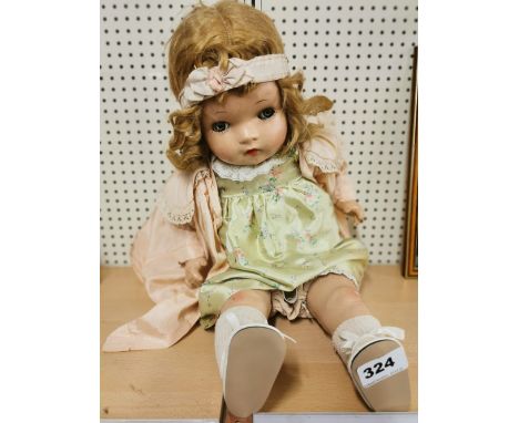 A vintage composition child doll by Horsman, with fluttering eyes and mamma cry, L. 57cm.