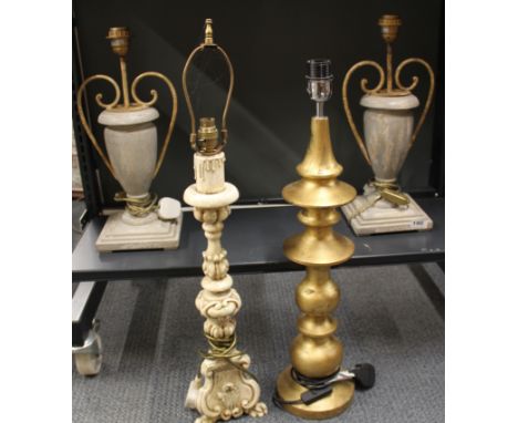 A pair of turned wood and metal table lamp bases, H. 47cm. Together with a gilt wood table lamp base and one other.