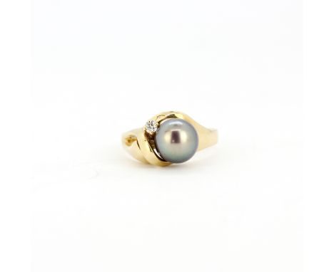 A yellow metal (tested minimum 9ct gold) ring set with a black cultured pearl and diamond, (N).