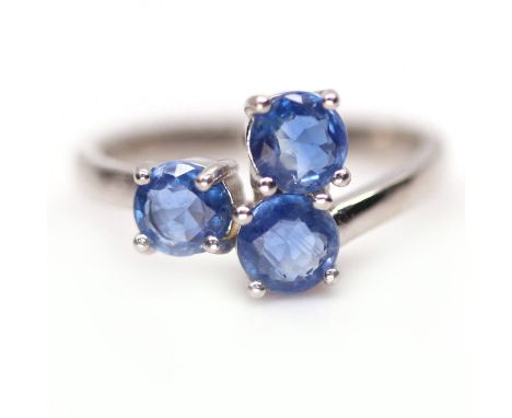 A 925 silver ring set with three round cut sapphires, (M).