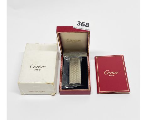 A boxed Cartier lighter.
