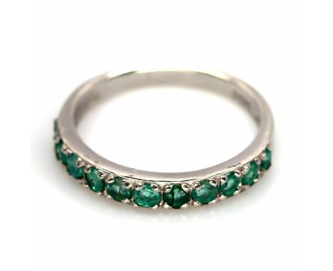 A 925 silver emerald set half eternity ring, (N).