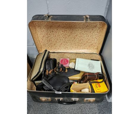 A vintage case and photographic items contents.