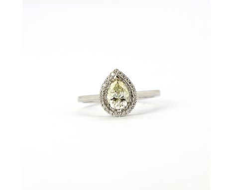 An 18ct white gold ring set with a pear cut diamond, approx. 0.75ct, surrounded by brilliant cut diamonds.