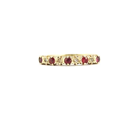 A hallmarked 9ct yellow gold ring set with round cut rubies and diamonds, (N.5).