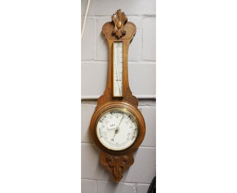 A large carved oak barometer and thermometer, H. 87cm.
