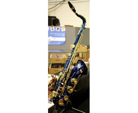 Stagg 77/ST tenor saxophone in blue with mother of pearl buttons, together with saxophone stand and fitted ABS case. P&amp;P 