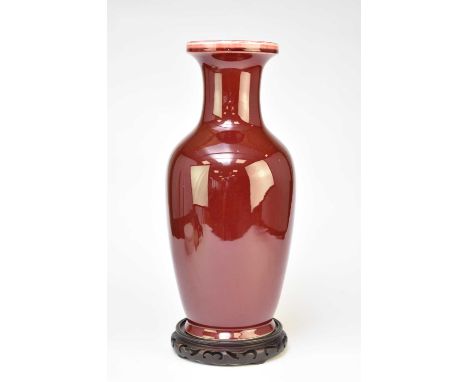 A large Chinese sang de beof vase, 20th century, of ovoid form with everted rim, decorated with an all-over copper red glaze 