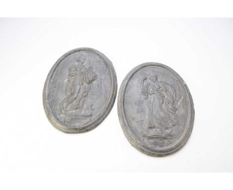 A pair of cast lead neoclassical architectural plaques, probably late 19th century, of oval form with moulded edges, each cas