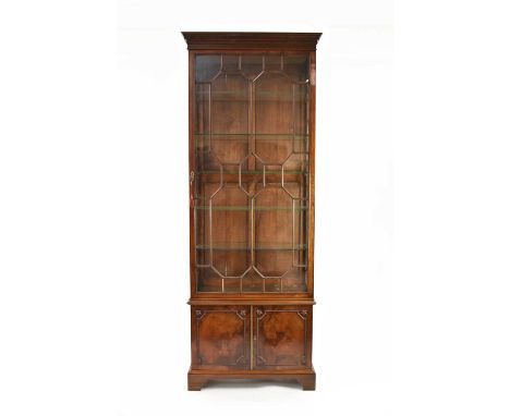 A Regency style mahogany glazed display cabinet, the ogee cornice with key moulding above a plain frieze, the twin astragal g