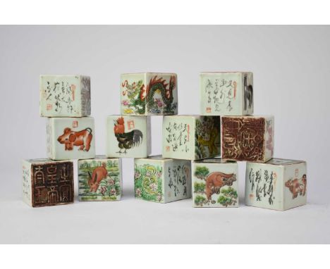 A set of twelve Chinese porcelain zodiac seals, 20th century, of cuboid form, each decorated with scenes of an animal and cur