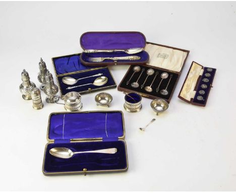 A collection of silver cruets and cased silver flatware, comprising; four pepper pots, three salts, a mustard, six coffee spo