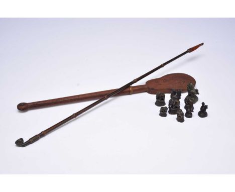 An Chinese opium pipe, bamboo with bronze bowl and resinous mouthpiece, 63cm long, together a group of bronze opium weights, 
