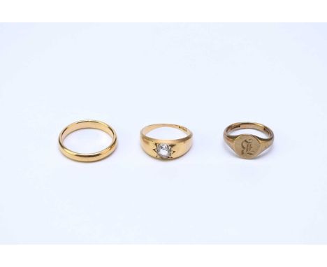 A 9ct gold signet ring, size K, together with a paste set ring, stamped '18ct' and a yellow metal band stamped '18ct', total 