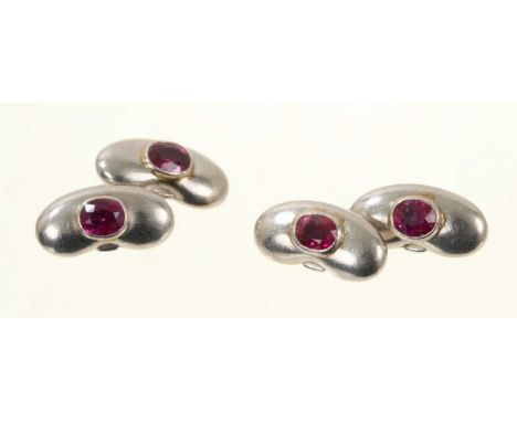 Pair of platinum and ruby cufflinks in the form of lucky beans, each with an oval mixed cut ruby in rub over setting.Good con