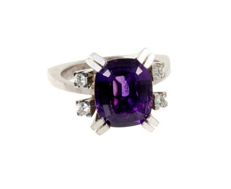 1970s amethyst and diamond ring with a cushion cut amethyst with exaggerated double claws flanked by brilliant cut diamonds t