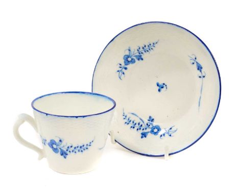 Caughley coffee cup and saucer, circa 1785, painted in blue with the Chantilly Sprigs pattern, with basket weave moulded bord