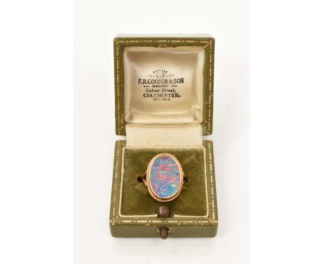 Opal single stone ring with an opal triplet measuring approximately 18 x 13mm in 9ct gold setting with rope twist border on p