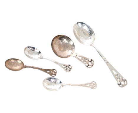 1920s silver caddy spoon, together with a matching compote spoon and three coffee spoons, in the Arts and Crafts manner, with