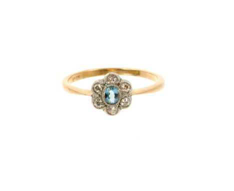 Edwardian aquamarine and diamond daisy cluster ring with an oval mixed cut aquamarine and six old cut diamonds in platinum mi