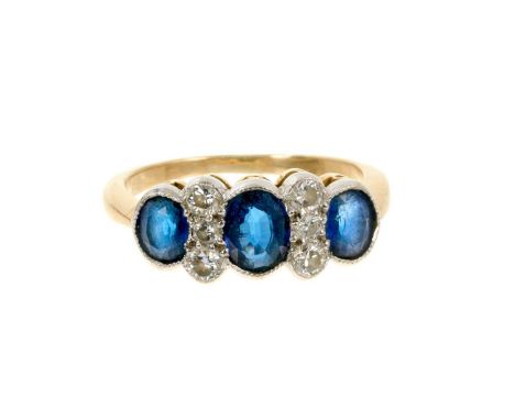 Sapphire and diamond ring with three oval mixed cut blue sapphires and six brilliant cut diamonds in millegrain setting on 18