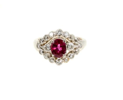 18ct white gold ruby and diamond cluster ring with a central oval mixed cut ruby flanked by two brilliant cut diamonds and a 