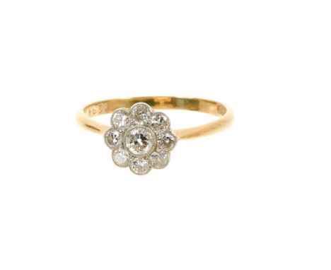 Edwardian diamond daisy cluster ring with nine old cut diamonds in platinum millegrain setting on 18ct gold shank, estimated 