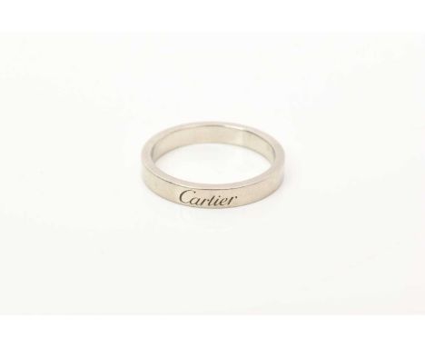 Cartier platinum wedding ring engraved 'Cartier' to the band, serial number TB9564, ring size N. Sold with a copy of the orig