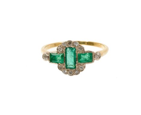 Art Deco emerald and diamond ring with three rectangular step cut emeralds surrounded by a border of old cut diamonds in plat