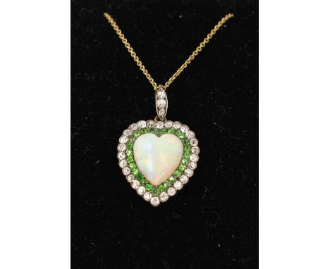 A fine late Victorian opal diamond and green garnet heart shape pendant with a central heart shape opal cabochon surrounded b