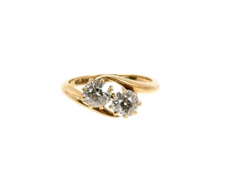 Diamond two-stone ring with two old cut diamonds estimated to weigh approximately 0.60cts each, in gold crossover setting. Es