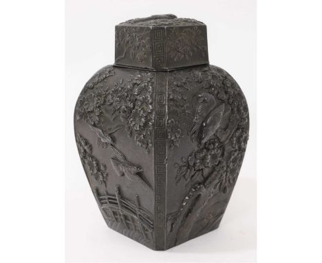Late 19th/early 20th century Japanese bronzed tea caddy and cover, of squared baluster form, relief moulded with flowering tr