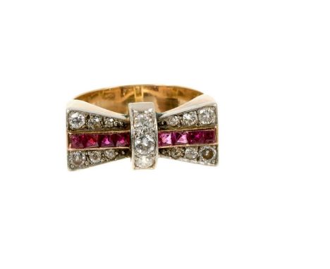 Art Deco Odeonesque diamond and ruby ring in the form of a bow, circa 1950, with a line of calibre cut rubies and old cut dia