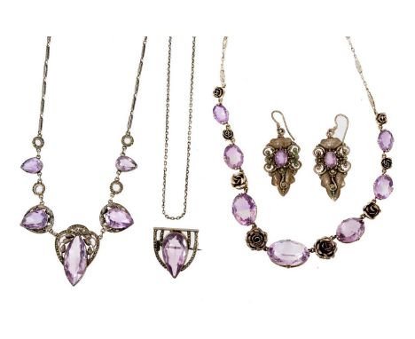 An Art Deco amethyst and silver necklace, another with silver roses and oval mixed cut amethysts, a pair of earrings and a br