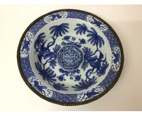 18th century blue and white delftware bowl painted in the Chinese style with exotic birds and horses, with fluted brass rim, 