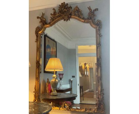 Good 19th century rococo revival wall mirror, with shaped bevelled plate in ornate cushion and scroll moulded frame, with roc
