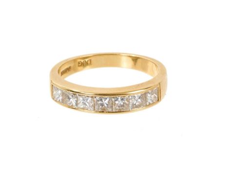 Diamond eternity ring with seven princess cut diamonds in 18ct yellow gold channel setting, London 1993. Estimated total diam